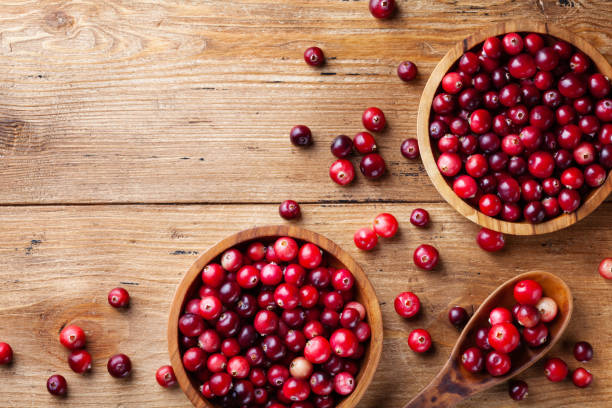 istock Cranberry in wooden bowl on rustic table from above. 1174640078