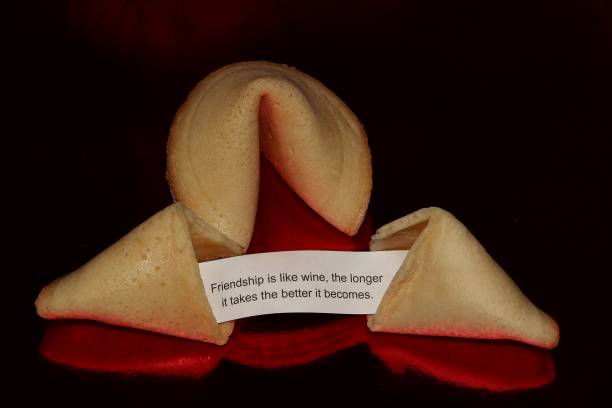 istock fortune telling cookies with a text about friendship is lying on a red reflection ground 1174641510