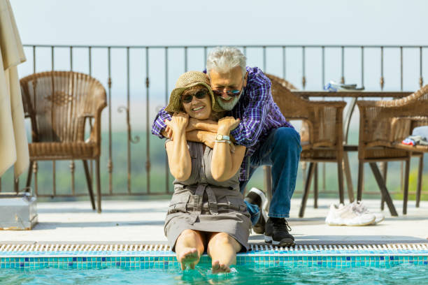 istock Senior couple interacting with each other at poolside 1174642334