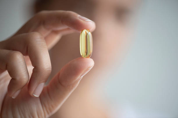 istock Woman Showing Soft Capsule 1174642621