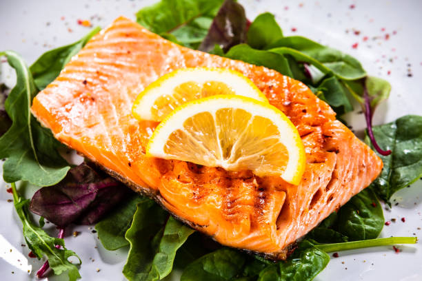 istock Grilled salmon on fresh vegetables on wooden table 1174643705