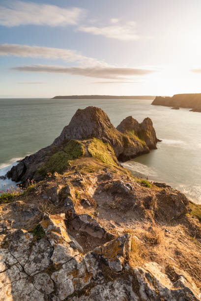 istock Beautiful peaceful Summer evening sunset beach landscape image at Three Cliffs Bay in South Wales 1174644236