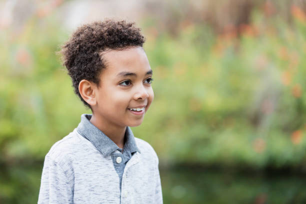 istock Confident mixed race boy at a park 1174646211