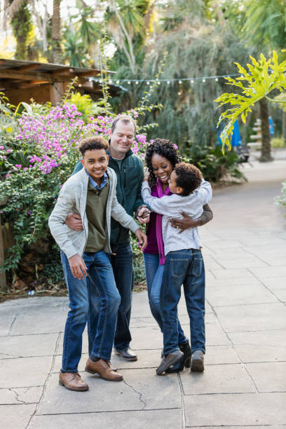 istock Interracial family with two boys at park 1174646568