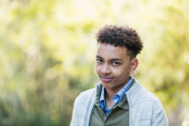 istock Mixed race boy standing outdoors in park 1174646709