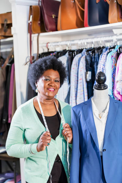 istock Woman working in men's clothing store 1174647771