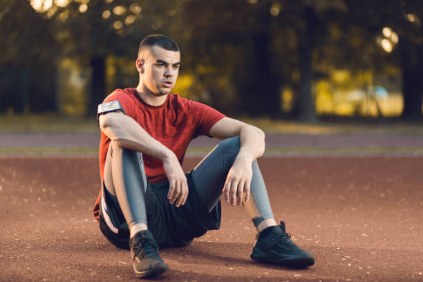 istock Exhausted athletic man resting outdoors 1174648491