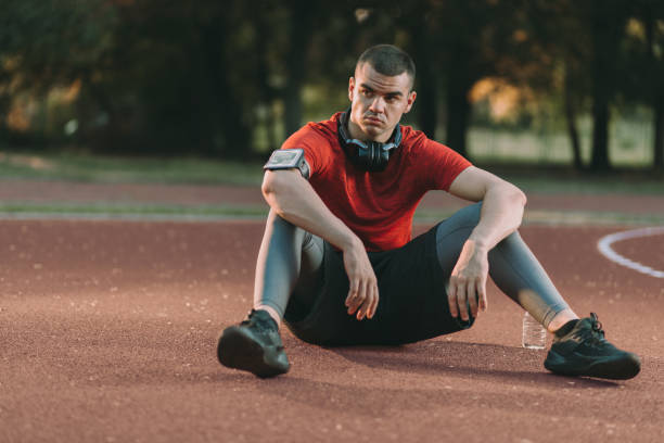 istock Exhausted athletic man resting outdoors 1174648546