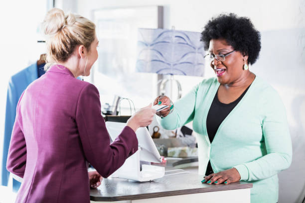 istock Saleswoman taking credit card from customer 1174648914