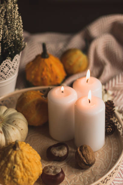 istock autumn cosy candles, pumpkin, and blanket 1174649962