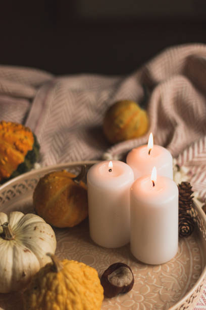 istock autumn cosy candles, pumpkin, and blanket 1174649963