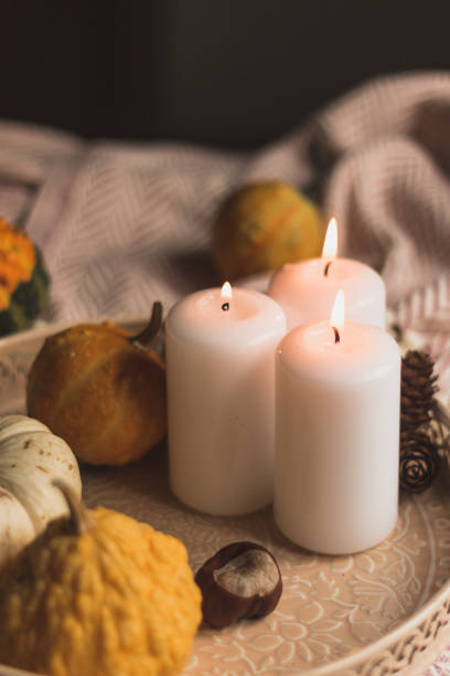 istock autumn cosy candles, pumpkin, and blanket 1174649968