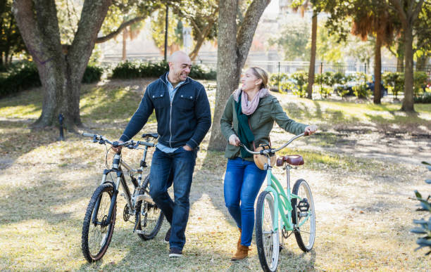 istock Hispanic couple in the park, riding bicycles 1174651035