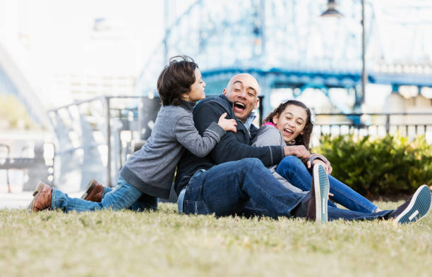 istock Hispanic father and two children, laughing together 1174651041