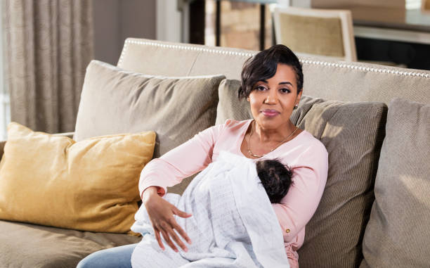 istock African-American mother nursing baby boy 1174653602