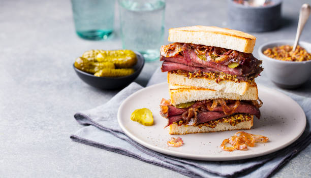 istock Roast beef sandwich on a plate with pickles. Copy space. 1174654247
