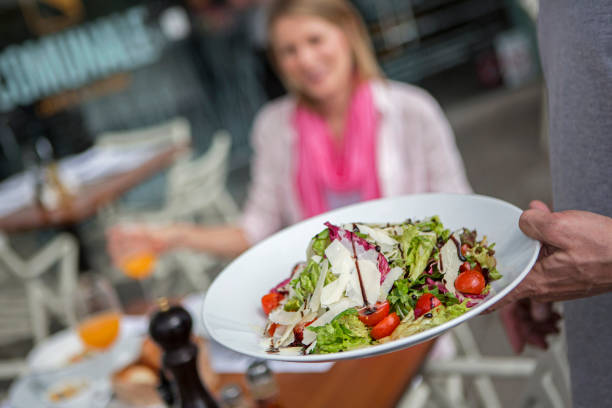 istock Waiter serving salad for woman 1174655156