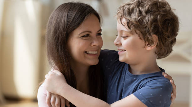 istock Young beautiful mother hugging little schoolboy son. 1174655327