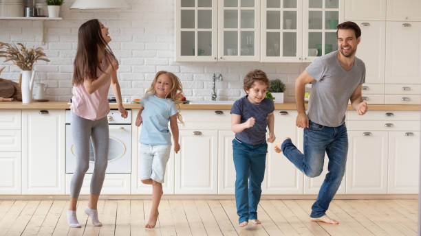 istock Full length happy family having fun together at modern kitchen. 1174655397