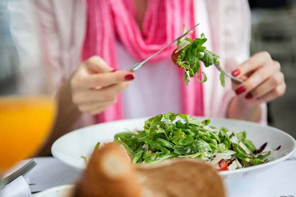 istock Woman eating salad 1174656173