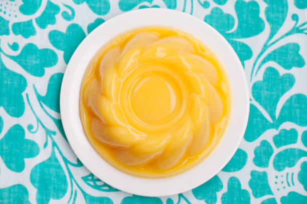 Mango pudding, jelly on white plate Blue textile background. Top view. Copy space. Mango pudding, jelly on white plate Blue textile background. Top view. Copy space gelatin dessert stock pictures, royalty-free photos & images