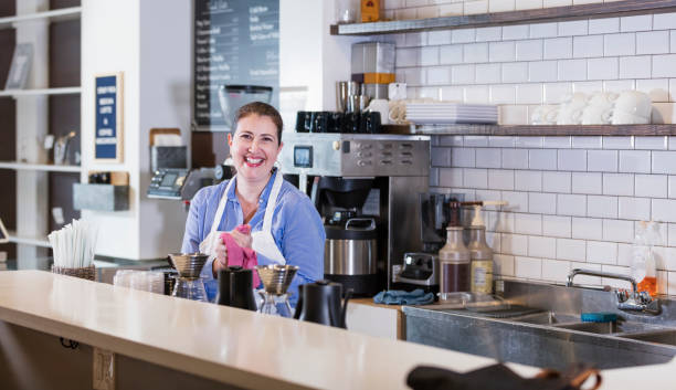 istock Hispanic woman working in coffee shop 1174656610