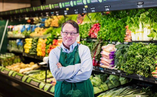 istock Man with down syndrome working in supermarket 1174658548