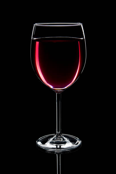 istock Glass of red wine on black background 1174658710