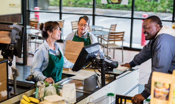 istock Customer and employees at supermarket checkout 1174658807