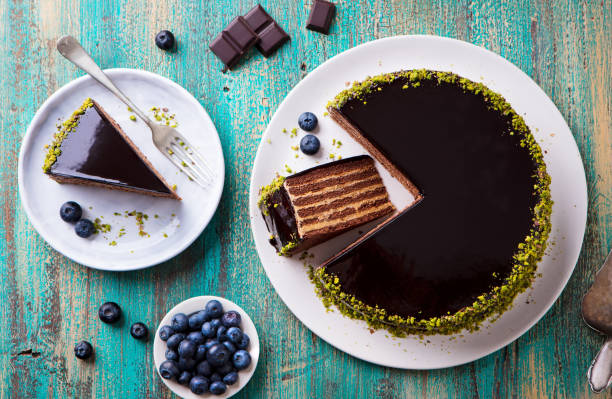 istock Chocolate cake on a white plate. Blue wooden background. Top view. 1174659816