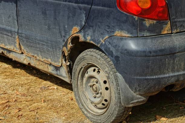istock old blue car with a rusty wing and a gray wheel 1174661121