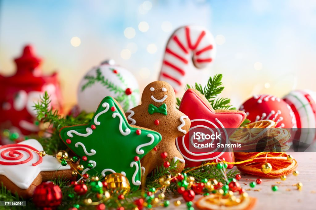 Festive concept with Christmas gingerbread in the shape of a star, fir branches and winter spices. Festive concept with Christmas gingerbread cookies, fir branches and winter spices. Christmas Stock Photo