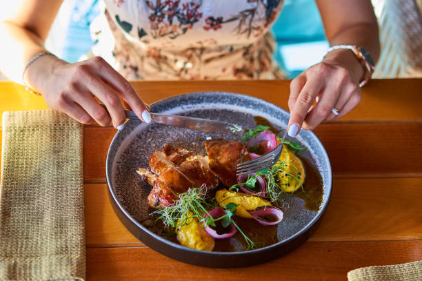 istock close - up of hands with a fork over a plate 1174663039