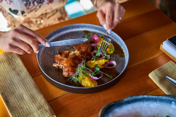 istock close - up of hands with a fork over a plate 1174663088