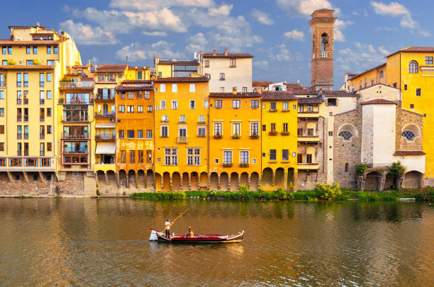 Florence, Italy - July 2,2019: A Florentine Gondola takes couple on private tour of the Arno River in Florence, Italy.