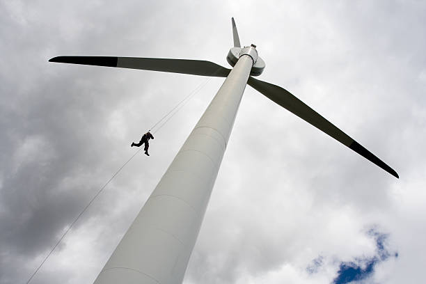 istock Person descending from wind turbine on a cloudy day 117466377