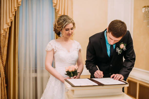 istock Wedding ceremony. Wedding couple leaving their signatures 1174677775