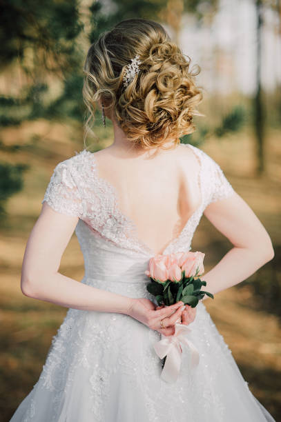 istock Back of beautiful bride with bridal bunch 1174677932