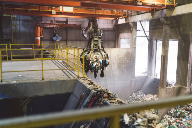 istock Machine picking up trash at recycling center 1174679912