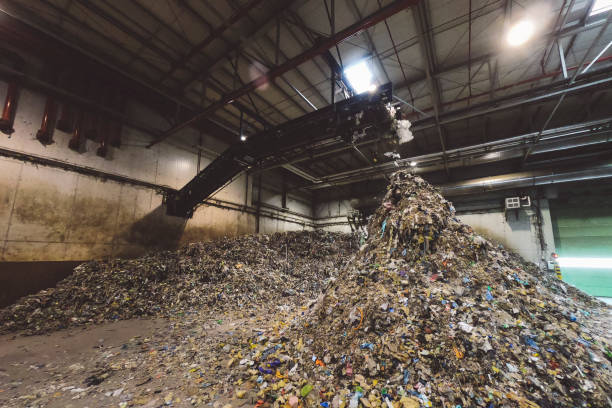 istock Shredded plastic falling off conveyor belt forming a pile 1174679917