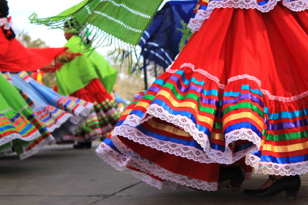 Colorful skirts fly during traditional Mexican dancing Close up of colorful skirts flying during traditional Mexican dancing. Young girls perform on a stage during an event celebrating Latino culture and heritage. customs stock pictures, royalty-free photos & images