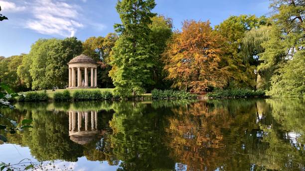istock Trees and leibniz monument with reflection on the water beautiful landscape view 1174688261