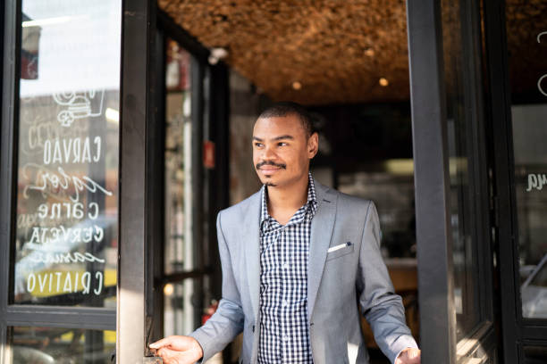 istock Business owner opening doors of restaurant 1174694122