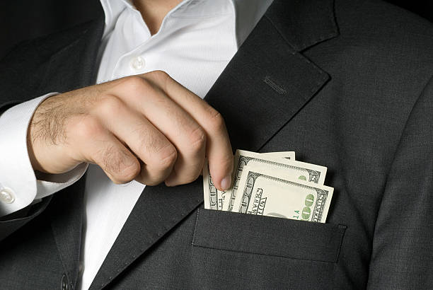 istock Businessman holding hundred dollar notes in jacket pocket, close-up 117469625