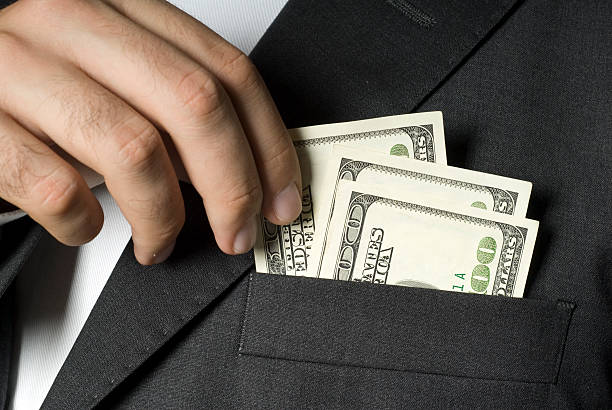 istock Businessman holding hundred dollar notes in jacket pocket, close-up 117469849