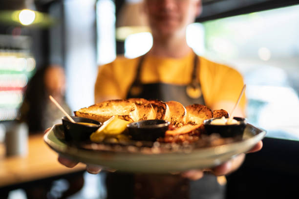 istock Owner / Waiter pride showing a gourmet plate 1174699924