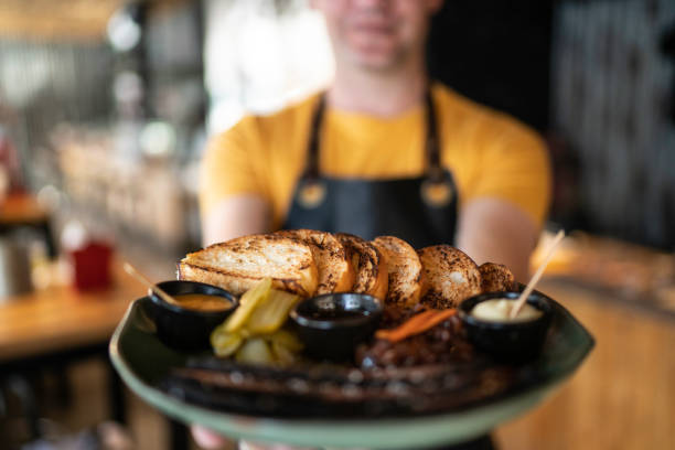 istock Owner / Waiter pride showing a gourmet plate 1174700554