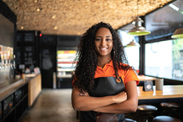 Portrait of african ethnicity waitress / owner at restaurant Portrait of african ethnicity waitress / owner at restaurant fast food restaurant stock pictures, royalty-free photos & images