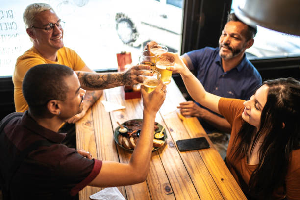 istock Group of friends toasting in a bar / restaurant 1174700913