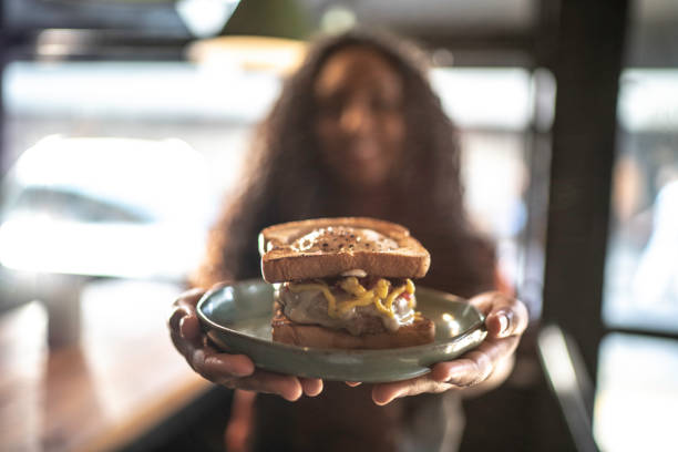 istock Waitress holding / showing a sandwich 1174706197